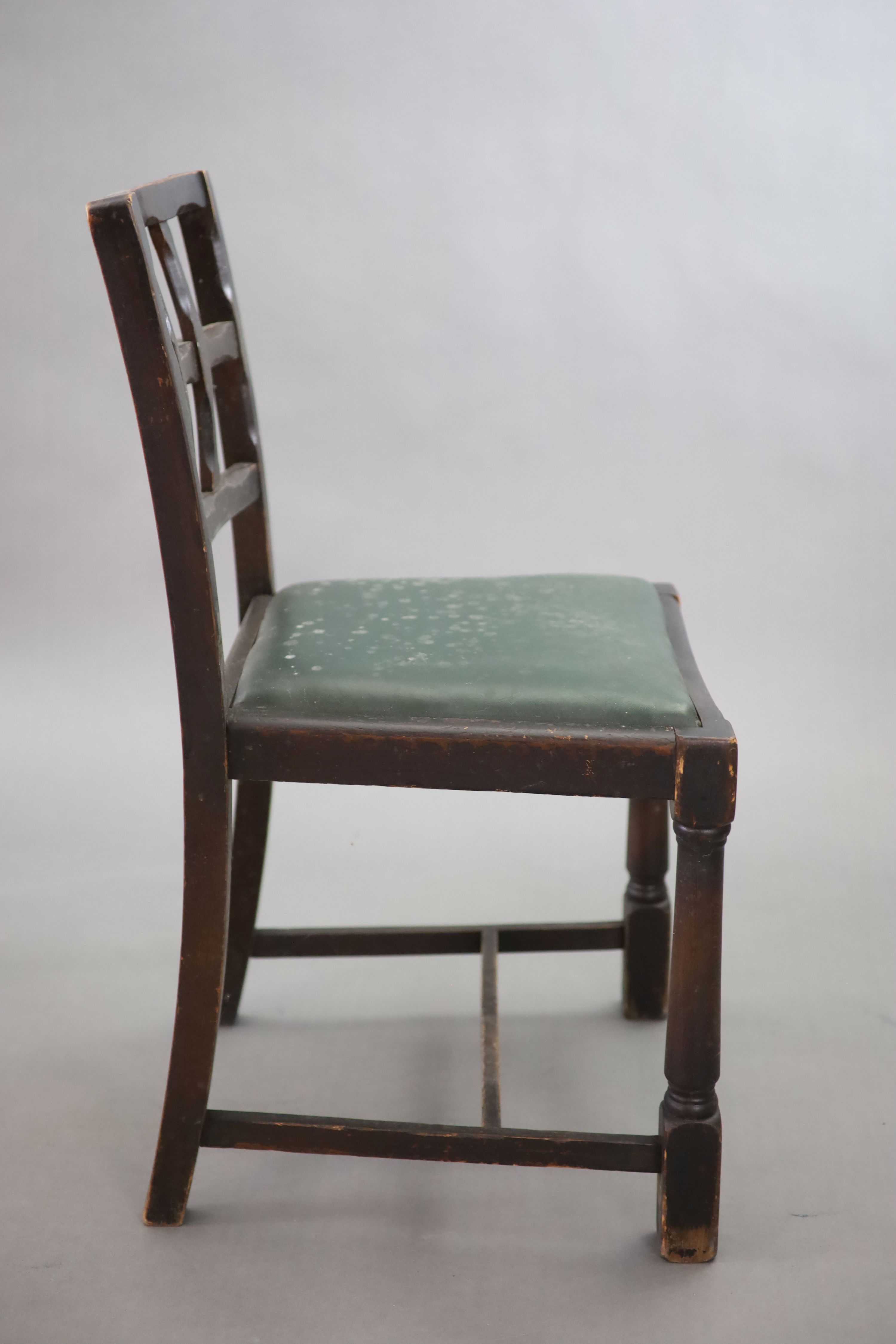 A set of twelve stained beech and oak dining chairs, with cross frame backs and drop-in seats, on turned and squared legs